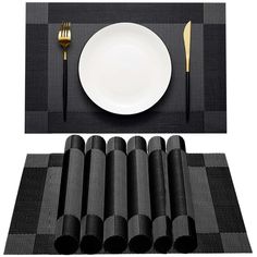 the place setting is ready to be served with black napkins, silverware and gold flatware