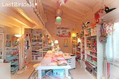 a room filled with lots of clutter next to a wooden ceiling covered in lights