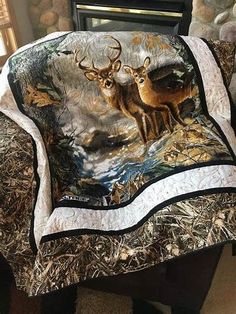 a chair covered in a blanket with two deers on it