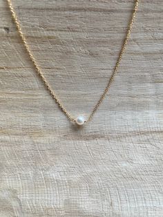 Perfect for your wedding day, bridesmaid or an everyday dainty pearl necklace!  -Handmade with love -Gold Filled 1.5 mm Cable Chain  -16 1/2 inch with spring ring clasp  -White Mini Round Pearl approximately 1/4 inch (5 mm) Notes:  💗This necklace is available in silver, rose gold filled and rose gold filled.  💗Happy to make this style in bulk for bridal parties upon request!! Classic Delicate Chain Necklace For Bridesmaid Gift, Minimalist Pearl Necklace With Charm For Bridesmaids, White Pearl Charm Necklace For Bridesmaid, White Pearl Charm Necklace For Bridesmaid Gift, Classic Pearl Chain Necklace For Bridesmaid, Simple Pearl White Wedding Jewelry, Pearl Necklace For Bridesmaid Gift, Simple Gold Pearl Necklace For Wedding, Pearl White Pearl Chain Necklace For Bridesmaids