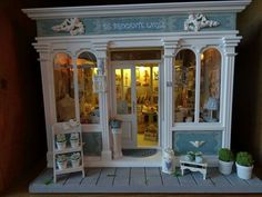 a doll house with furniture and decorations on display