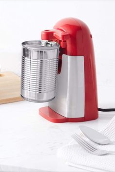 a red blender sitting on top of a white counter