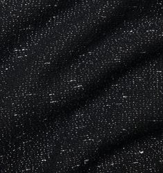 black fabric with white speckles and small dots on the side, close up