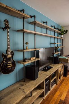 an entertainment center with shelves and guitars on the wall