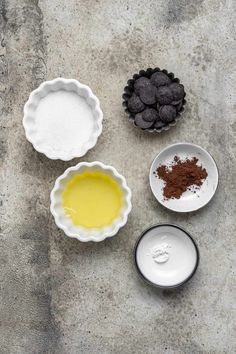 three bowls filled with different types of food on top of a cement floor next to each other