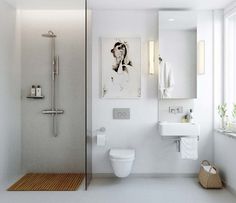 a bathroom with a toilet, sink, and shower stall in white color scheme on the wall