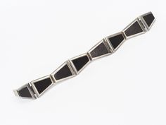 "ArtDecoGalaxy presents: an Art Deco cubistic sterling silver bracelet inlaid with ebony with a box lock, circa 1940s. Measures 20cm (7.87\") long by 2,2cm (0.87\") wide. Wear consistent with use and age, no damage or repairs, in excellent vintage condition. The shipping cost is for Standard Registered Mail. Please contact us to combine shipping or to request Express shipping. For all Countries not figured in the shipping list please contact us for a quote and shipping details. We will consider Modernist Geometric Jewelry For Formal Occasions, Contemporary Sterling Silver Bracelet For Formal Occasions, Modernist Sterling Silver Bracelet, Modern Evening Bracelet With Polished Finish, Modern Evening Bracelets With Polished Finish, Modern Polished Bracelet For Evening, Modern Polished Bracelets For Evening, Elegant Formal Bracelets With Inlay, Modern Bracelets With Polished Finish For Evening