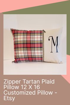 the zipper tartan plaid pillow is displayed on a pink and green background with an m monogrammed pillow