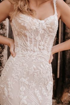 a woman in a wedding dress posing for the camera