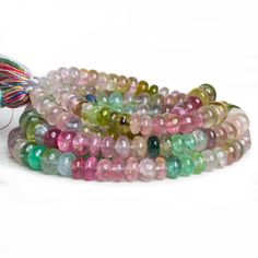 multicolored glass beads with tassels on white background