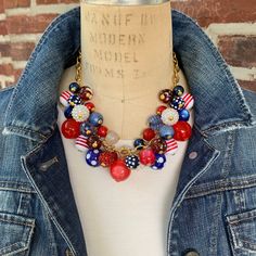 Red, white and blue statement necklace for Memorial Day, 4th of July or every day.  Chunky charm necklace filled with a mix of fascinating beads in reds, white, blue, polka dots and stripes. The beads are securely wire-wrapped to perfection on our signature brass-plated cable chain, 18" long with a 3" extension. Red Patriotic Necklace For 4th Of July, Patriotic Round Beads Necklace As Gift, Patriotic Blue Beaded Necklaces, Patriotic Round Beads Necklace Gift, Adjustable Patriotic Red Necklace, Blue Beaded Necklaces For 4th Of July, Patriotic Blue Beaded Necklace, Blue Beaded Necklace For 4th Of July, Patriotic Beaded Necklace For Gift