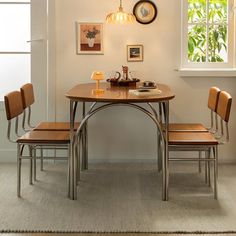 a dining room table with four chairs around it