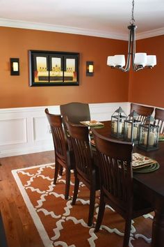 a dinning room table with chairs and candles on it