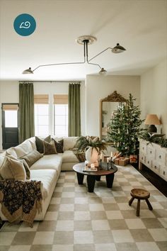 a living room filled with furniture and a christmas tree in the middle of the room