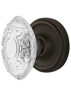 an antique style glass door knob with a decorative design on the front and back of it