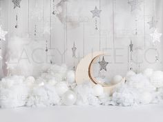 an image of a moon and stars in the sky with white snow on the ground