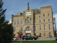 an old building with cars parked in front