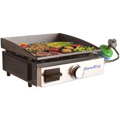 an electric grill with various foods cooking on it's side and the lid open