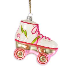 an ornament shaped like a roller skate with pink and green wheels hanging from a rope