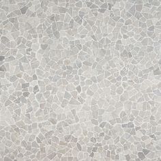 a white and grey tile background with small rocks