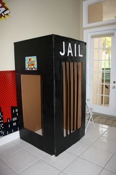 a cardboard jail in the middle of a room