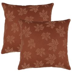 two brown pillows with leaves on them