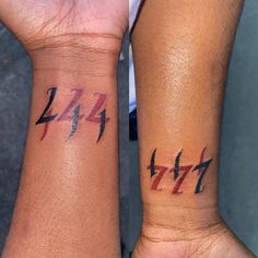 two people with matching tattoos on their arms, one has the letter z and the other has an arrow