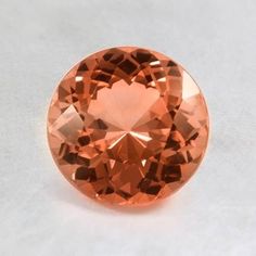 an orange diamond on a white surface