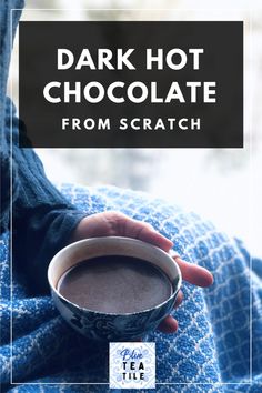 a person holding a cup of hot chocolate in their hand with the title dark hot chocolate from scratch