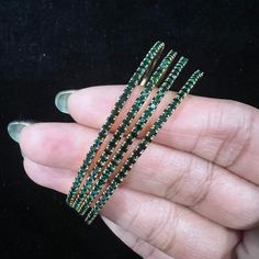 "*  Handcrafted Gold Plated 4 Bangle Set. Sold as a set. * Bangles with pretty black and green stones * High Quality 22 K Gold Plated- 4 Bangle set Bangles Sizes : Size 2.4 ( 2.31\" inner circle diameter) ; Size 2.6 (2.40\" inner circle diameter;)  Size 2.8 (2.50\" inner circle diameter) Gorgeous gold-plated bangle/ bracelet best exemplifies the careful craftsmanship done on it -- a specialty at Nemali Jewelry. It has a special tone of elegance attached to it. The intricate handmade design of the bangle/bracelet set gives it a fresh and original look.  Look your best with this elegant-looking bangle / bracelet set from the house of Nemali Jewelry. This set looks elegant at first glance. You can Mix and match or easily pair it up with Glass bangles, Thread work bangles, Stone or Kundan bang Stackable Round Bangle For Party, Black Bangles Set, Black Bangles, Wedding Bangles, Black Bangle, Kundan Bangles, Glass Bangles, Bangles Set, The Bangles