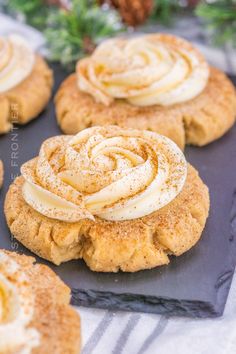 cinnamon roll cookies with icing on a black plate