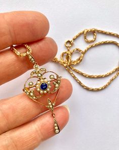 An absolutely stunning Art Nouveau sapphire and baby seed pearl solid 9ct gold Edwardian necklace.  The pendant section of this necklace can slide off the chain and be worn as a brooch. The brooch fittings are very secure. The solid 9ct gold chain is a very unusual twist rope style and is a gorgeous substantial 2.1mm thick It has a beautiful lustre and really catches the light when worn.  Condition: Excellent Pendant/ brooch size: 5cm x 2cm Chain length: 20.5 inches ( 52cm ) Weight: 9.9g **This Victorian Birthstone Necklaces For Anniversary, Victorian Birthstone Necklace For Anniversary, Victorian Pearl Pendant Necklace, Vintage Sapphire Necklaces For Anniversary, Vintage Sapphire Necklace For Anniversary, Victorian Yellow Gold Necklace With Pearl Pendant, Victorian 14k Gold Necklace With Pearl Pendant, Victorian Style Hallmarked Sapphire Jewelry, Vintage Sapphire Pendant Necklaces