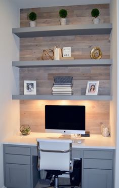 a desk with a computer on top of it and shelves above the desk in front of it