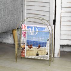 a magazine rack sitting on the floor in front of a door