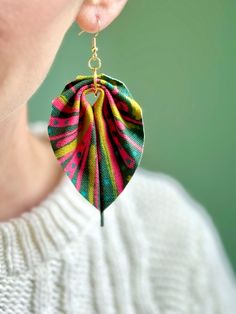 a close up of a person wearing some kind of earring that has been made out of fabric