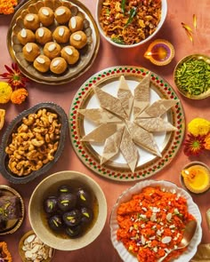 a table topped with plates and bowls filled with different types of food next to each other