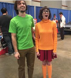 two people dressed up in costumes standing next to each other and one has his mouth open