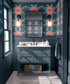 a bathroom with blue walls and orange flowers on the wall, along with two sinks