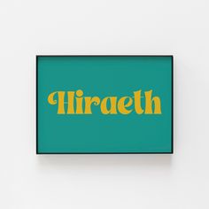 a green and yellow framed sign that says hiraeth on it's side