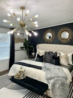 a bedroom decorated in black, white and gold