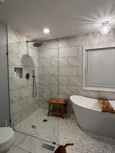 a white bath tub sitting next to a walk in shower