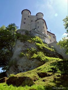 an old castle sitting on top of a hill