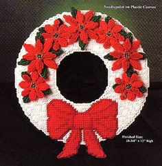 a crocheted christmas wreath with red poinsettis