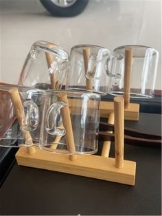 the cups are lined up with wooden spoons