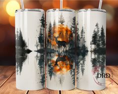 three stainless steel tumblers with an image of a deer in the woods and trees