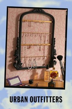 an advertisement for the urban outfitters, featuring a mirror and earring holder on a desk