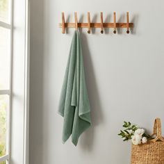 a towel hanging on the wall next to a basket