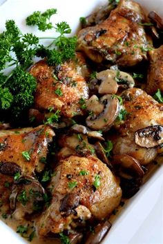 chicken with mushrooms and parsley in a white dish