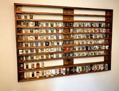 a wooden shelf filled with lots of cups