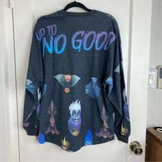 an ugly sweater hanging on a door with the words up to no good printed on it